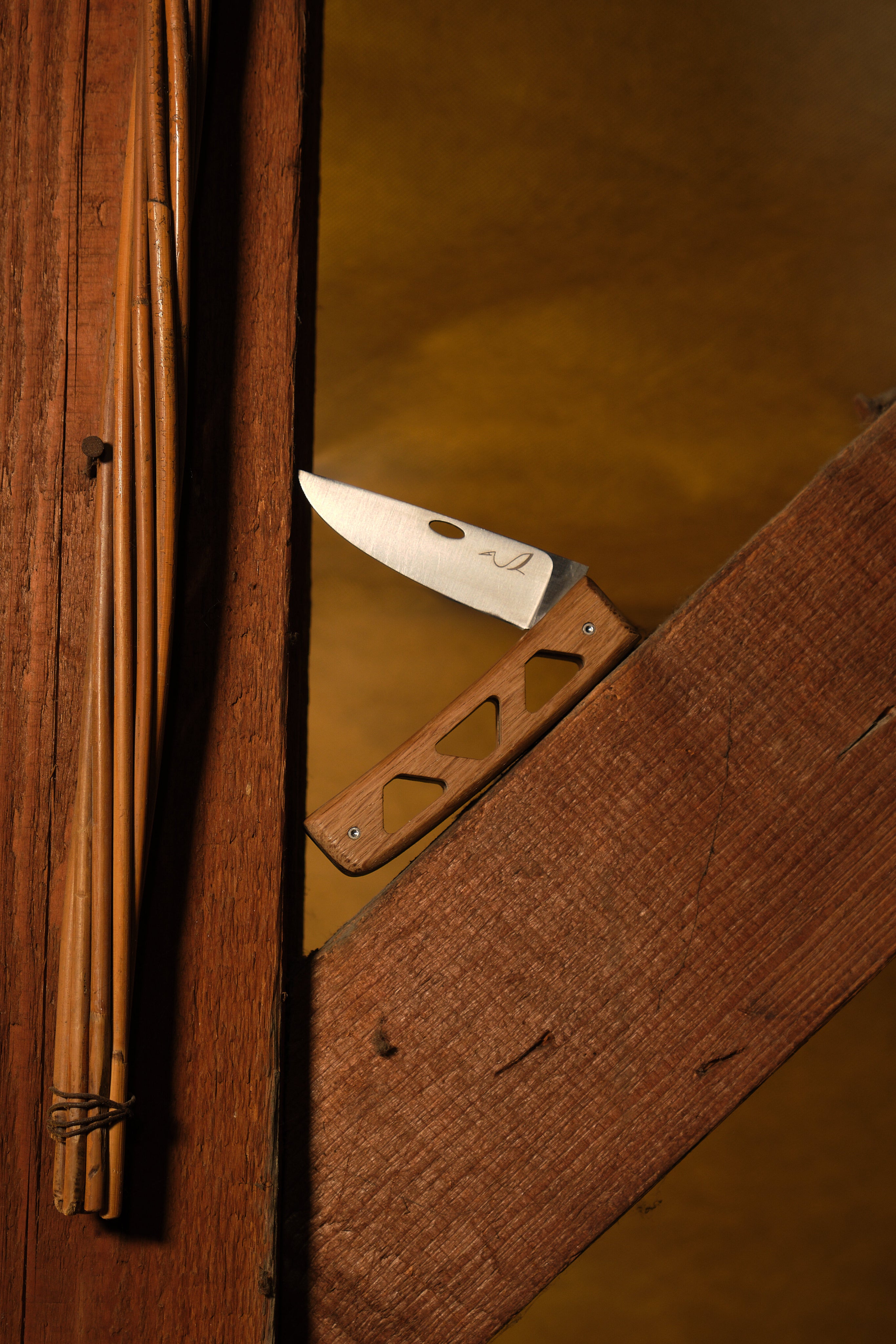 couteau pliant placé sur une poutre 